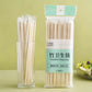 Pack of 20 bamboo chopsticks shown standing in a clear glass cup next to their retail packaging, on a light green background.