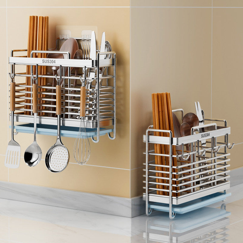 A wall-mounted stainless steel dish rack with hanging utensil holders, shown in two configurations against beige tiled walls. The rack holds wooden chopsticks, bowls, plates, and metal cookware, with the text 'SUS304' visible on the front.